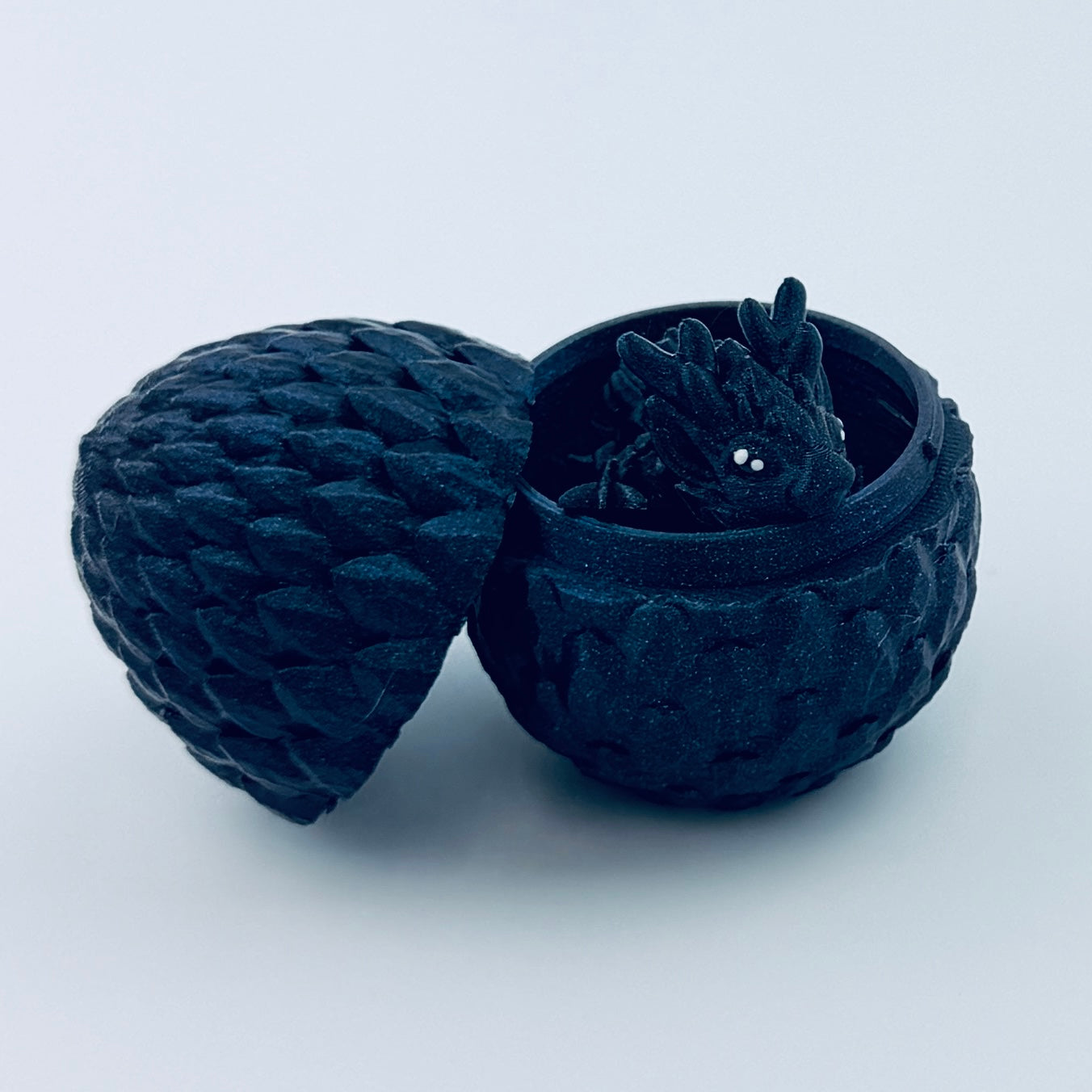 3d printed teeny dragon in egg - titanium