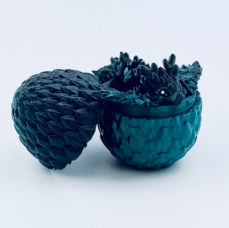 3d printed teeny dragon in egg - titanium
