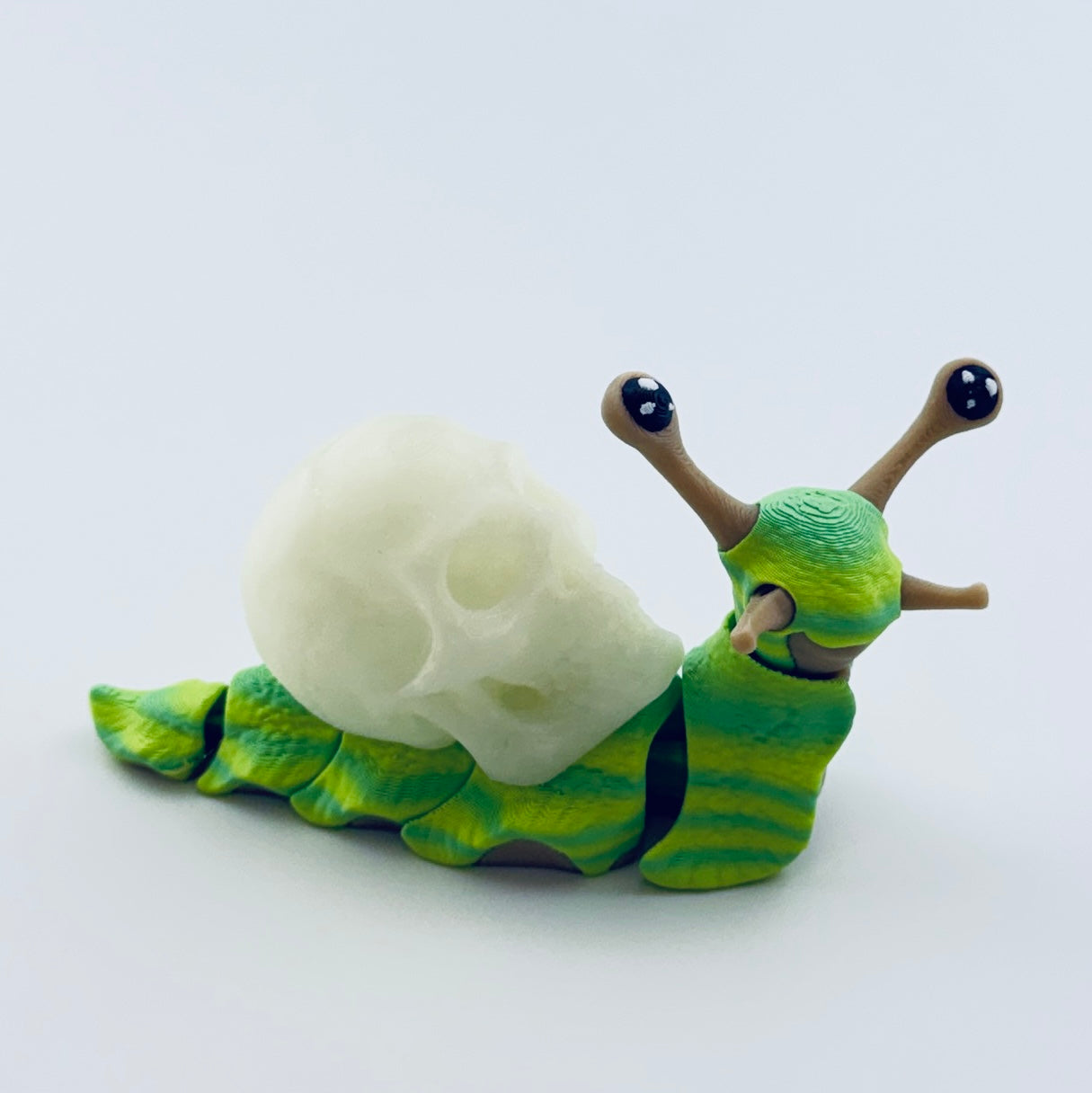 articulated snail with glow in dark skull shell